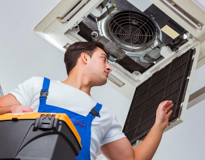 man repairing a vent